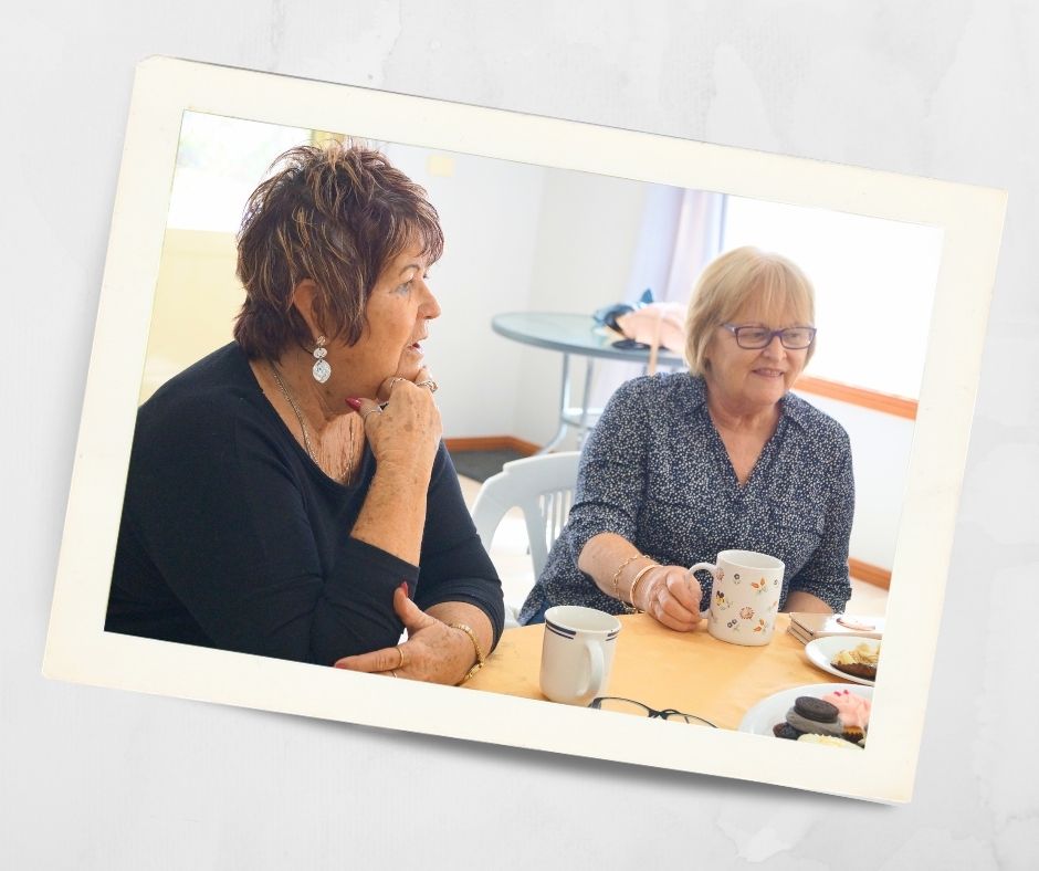 Two women sharing tea and conversation inside a retirement village in Lithgow, enjoying friendship and community life at Kirkley Gardens.