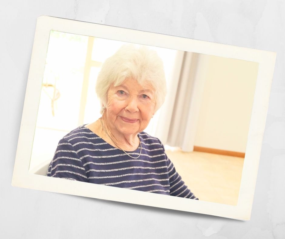 Resident smiling inside the community centre at Kirkley Gardens independent living retirement village in Lithgow