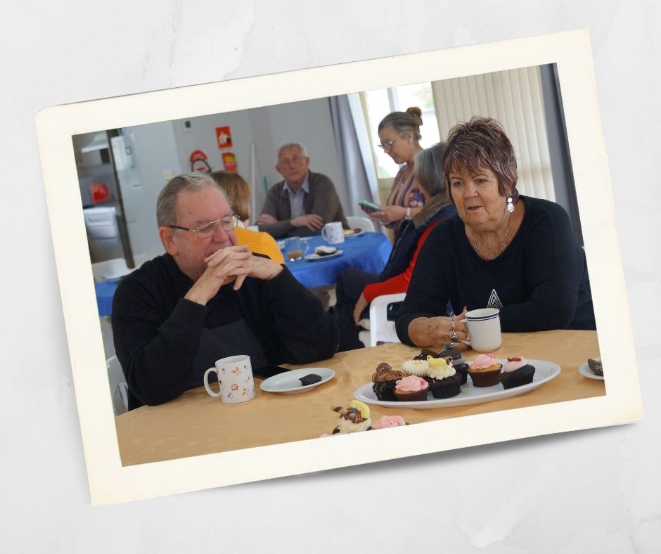 Residents enjoying tea, coffee and cupcakes together at an indoor social gathering at a retirement village near Lithgow and the Blue Mountains.